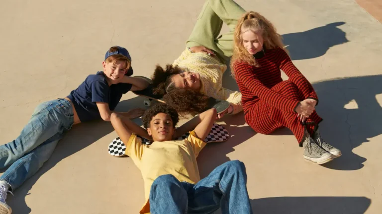 Group of Gen Alpha kids relaxing together outdoors with skateboards, smiling and enjoying the sun — friendly and playful vibe suitable for a Dream Job lesson plan theme.