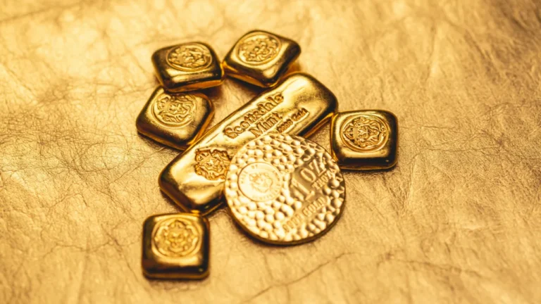 Gold bars and coins on wooden surface for advanced ESL lesson plan about precious metals investment and trading decisions