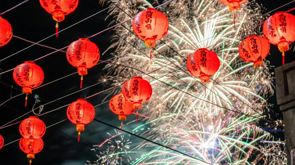 Chinese New Year lanterns and fireworks celebration with traditional red decorations lighting up the night sky during festival