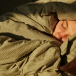 A person sleeping peacefully in bed — perfect image to introduce the B1 lesson plan on sleepcations.
