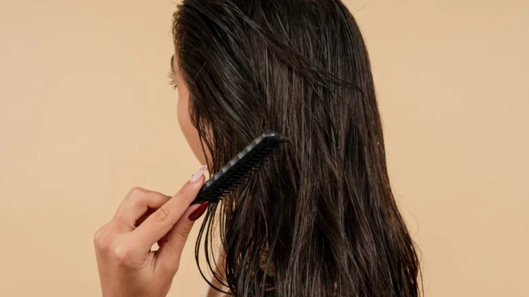 B1 English lesson plan on getting a haircut — woman combing long wet dark hair after washing, beige background.