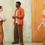 Two people having a casual conversation in an office hallway -- perfect for a British small talk lesson plan for A2 learners.