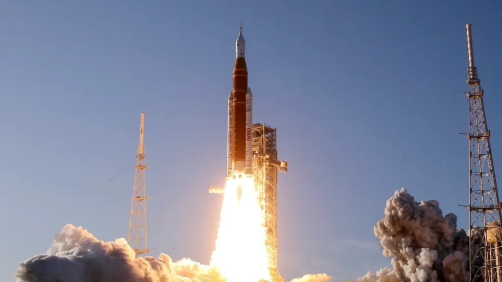 NASA Artemis rocket launches into blue sky, billowing smoke and flames at liftoff, space exploration lesson