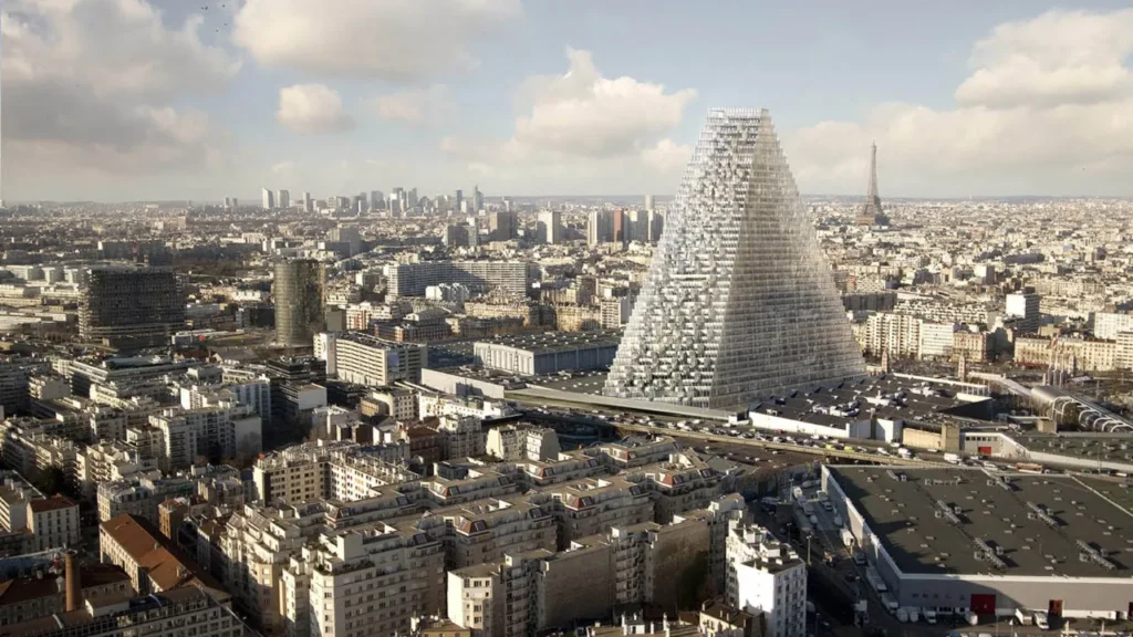 A aerial view of Tour Triangle, a glass pyramid skyscraper rising above the Paris skyline, with the Eiffel Tower visible behind it.